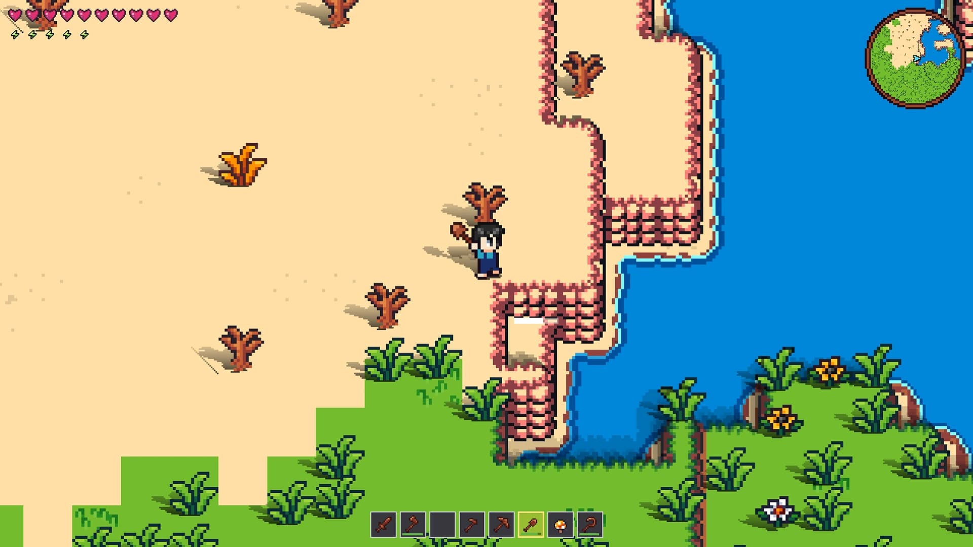A stone path built by a player winding across sand to the water's edge on a Vestalborne coastline